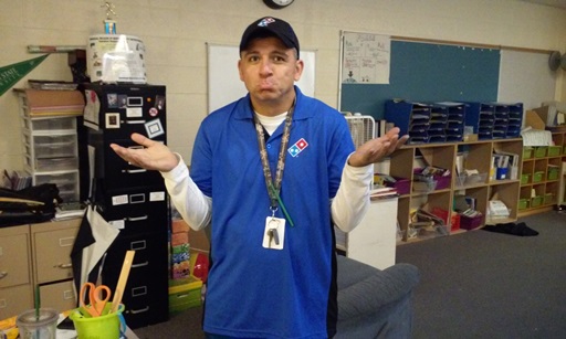 Mr. Garay, our 3rd grade teacher, pouts while wearing a Domino's pizza outfit. Not quite the domino outfit the rest of the staff has in mind.