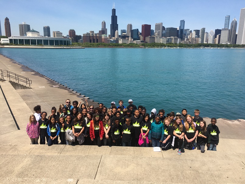The fifth graders stand with the Chicago skyline behind them.